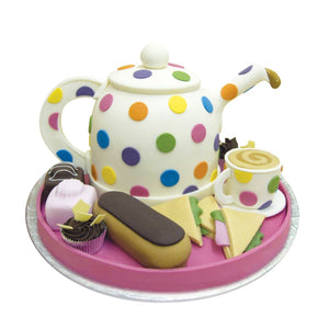 Tea time with teapot, cup, sandwiches and pastries all in cake