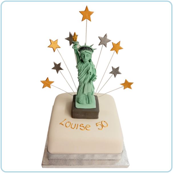 A cake featuring an edible model of the Statue of Liberty, with shooting stars behind the model.